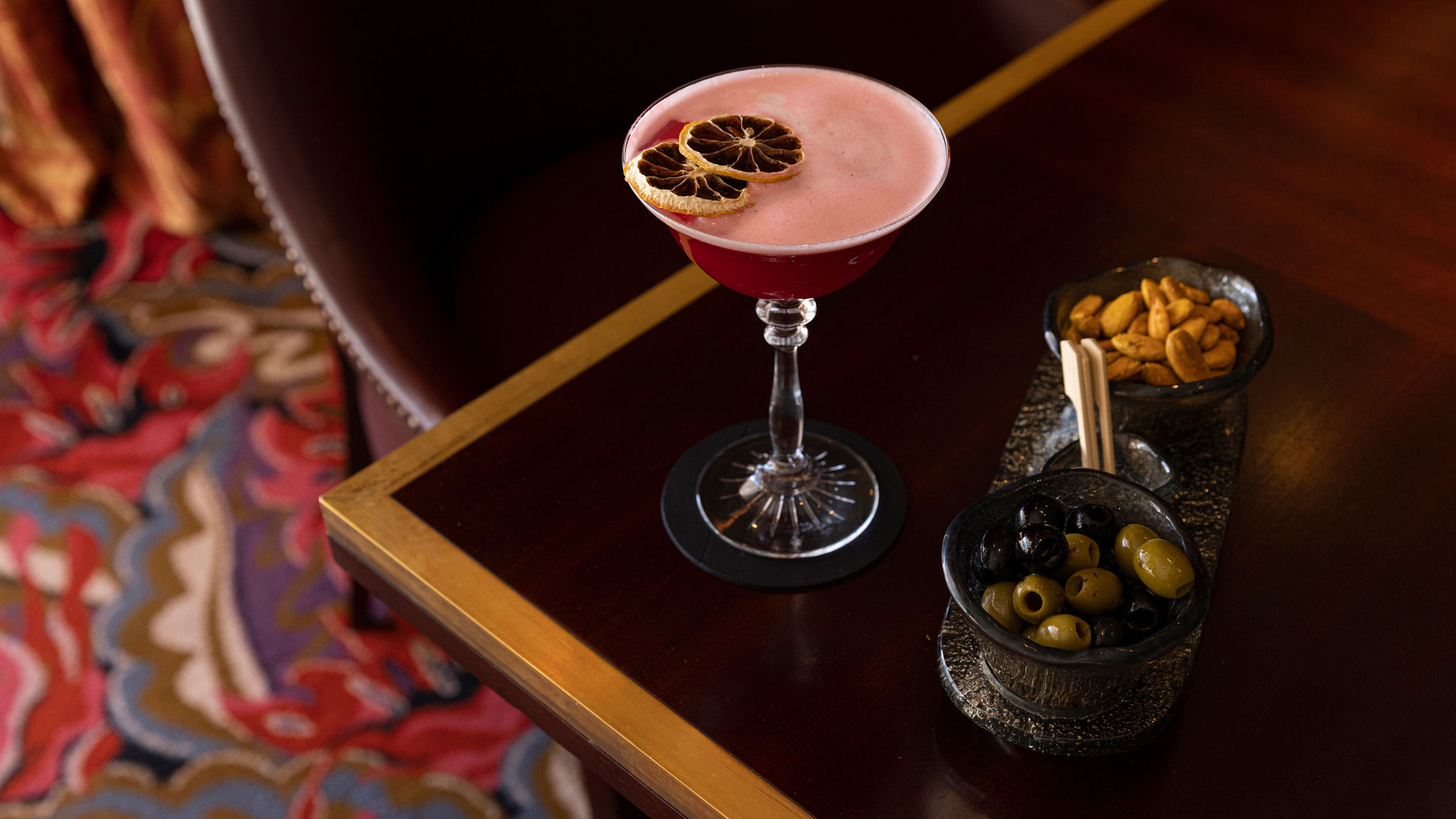 elegant cocktail with bar snacks at Ritz Bar in Four Seasons Ritz Lisbon