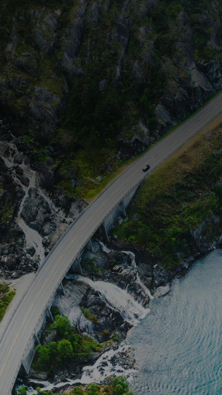 Aerial view of a truck driving along a winding coastal highway beside blue water, used on GIA Group, LLC’s Certificate of Insurance page to symbolize speed, reliability, and nationwide coverage.