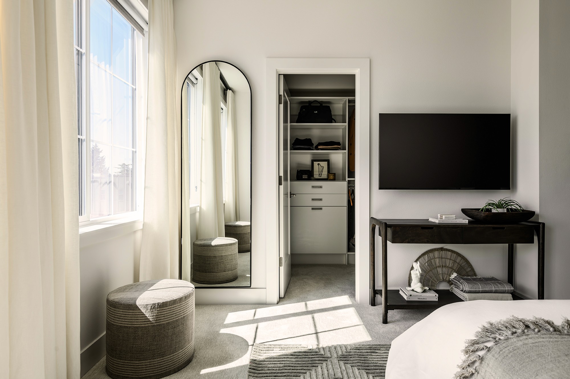 An organized and designed walk in closet in this home in Seattle, Washington by professional organizing firm, Elegant Simplicity.