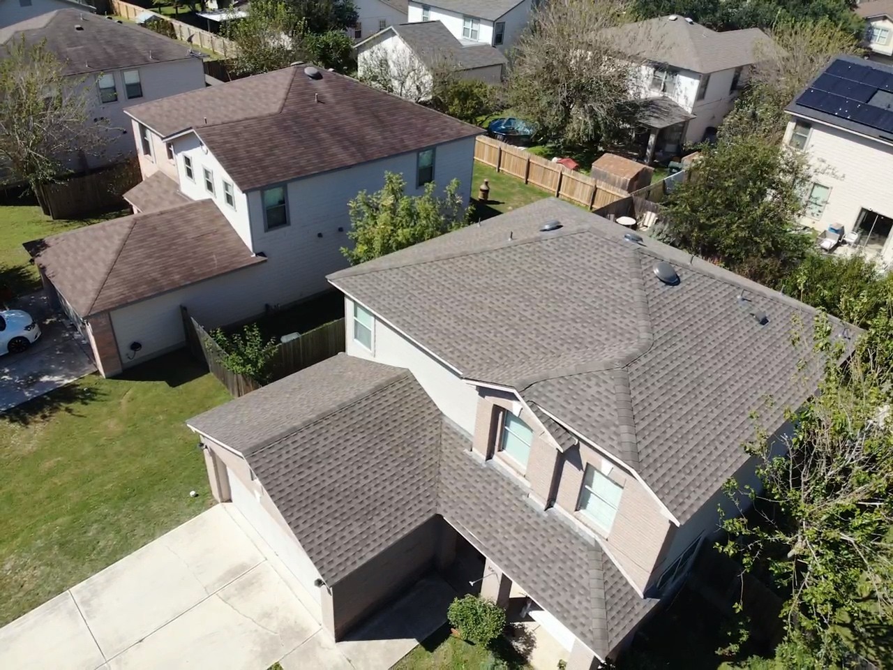 Two-story house with a hip roof design and dome vents. The roof features sloping sides that meet at the top, with small dome-shaped vents positioned on the roof for ventilation. The house has a classic, elegant appearance, with the vents adding a functional yet aesthetic touch to the structure.