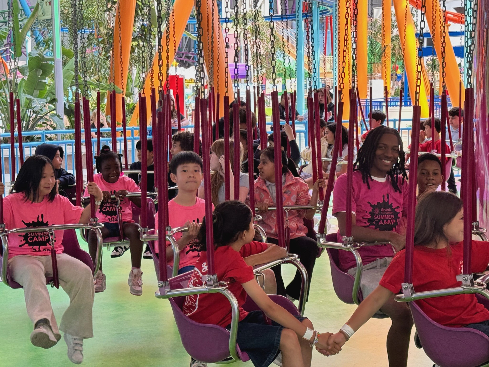 Participants ride an amusement park swing ride.