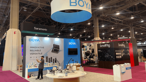 Saramonic BOYA NAB Show audio broadcast presentation booth with product display counters, hanging signage, branded presentation walls, and meeting support layout