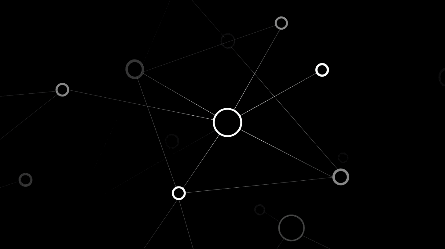 A woman with short curly hair wearing a black t-shirt looks into the camera.