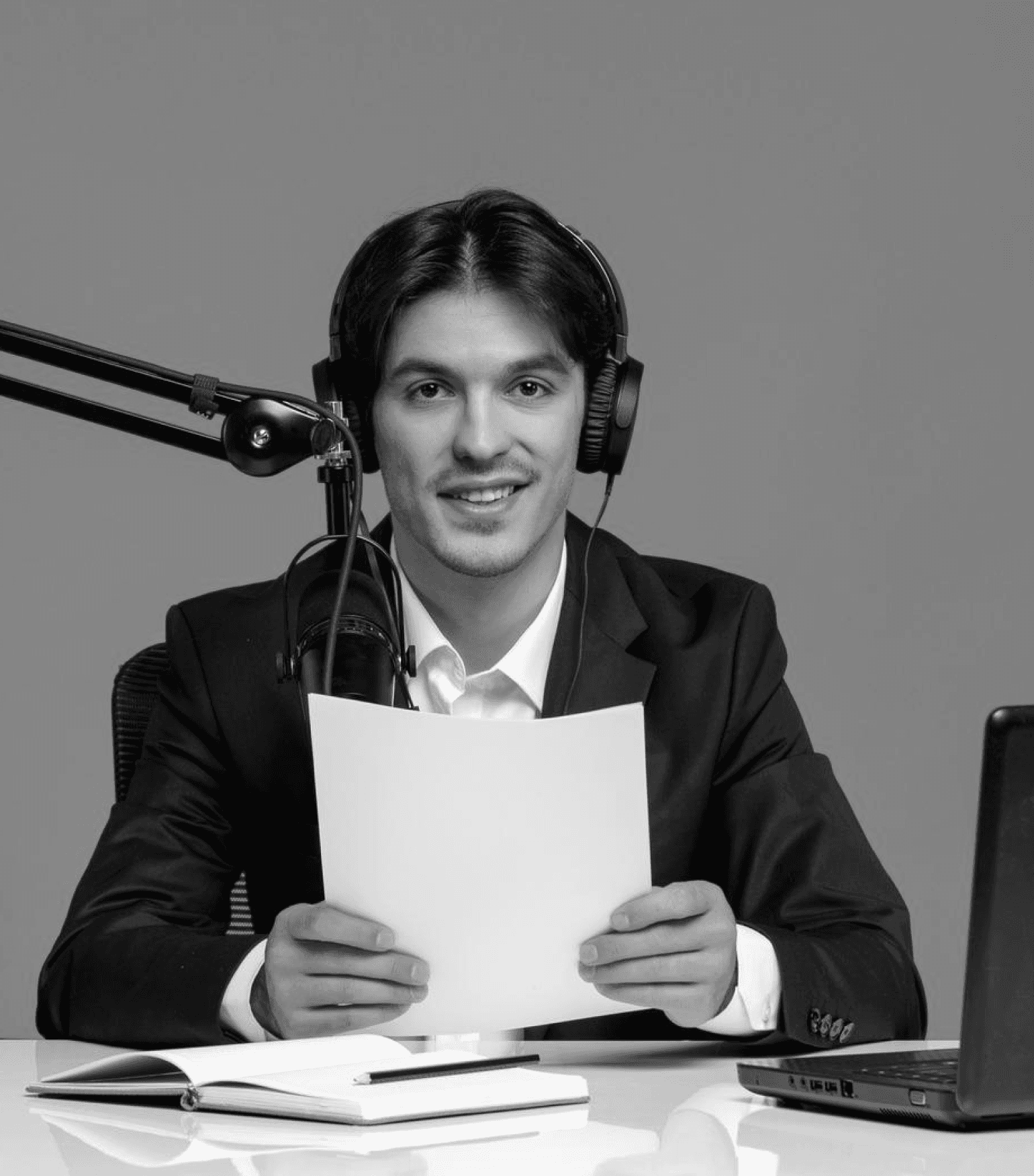 Man wearing headphones while recording a podcast.
