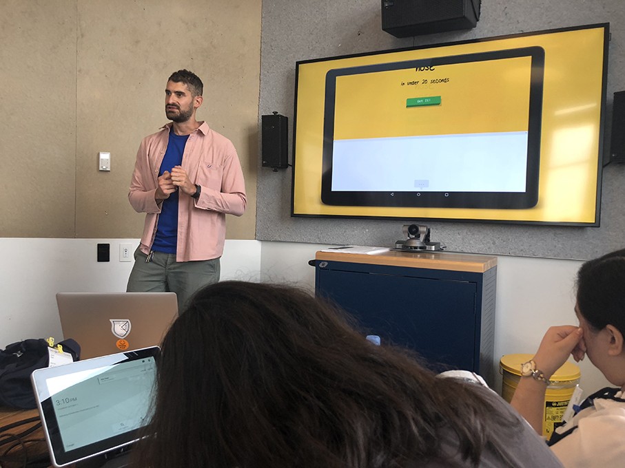 a course class with students and the teacher presenting the design lesson