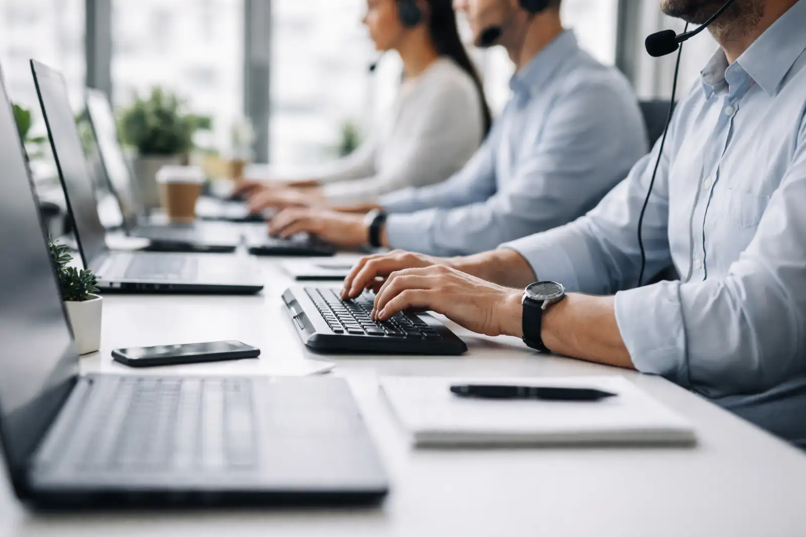 Operatori di assistenza clienti al lavoro in ufficio con cuffie e computer