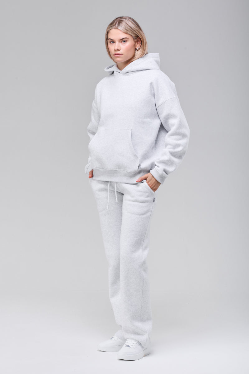 Model wearing grey boxy hoodie, full figure