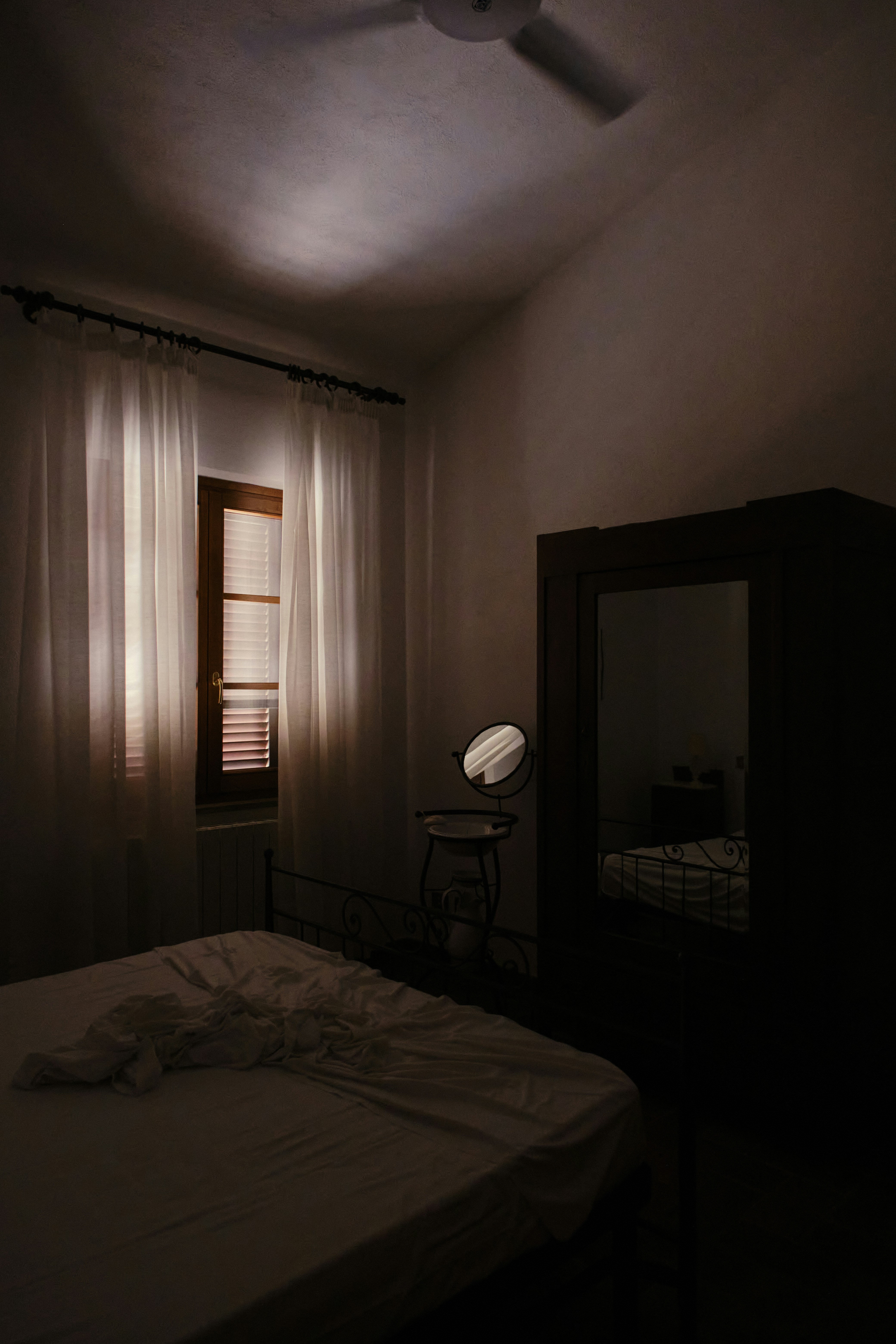 a bedroom with a bed and a mirror