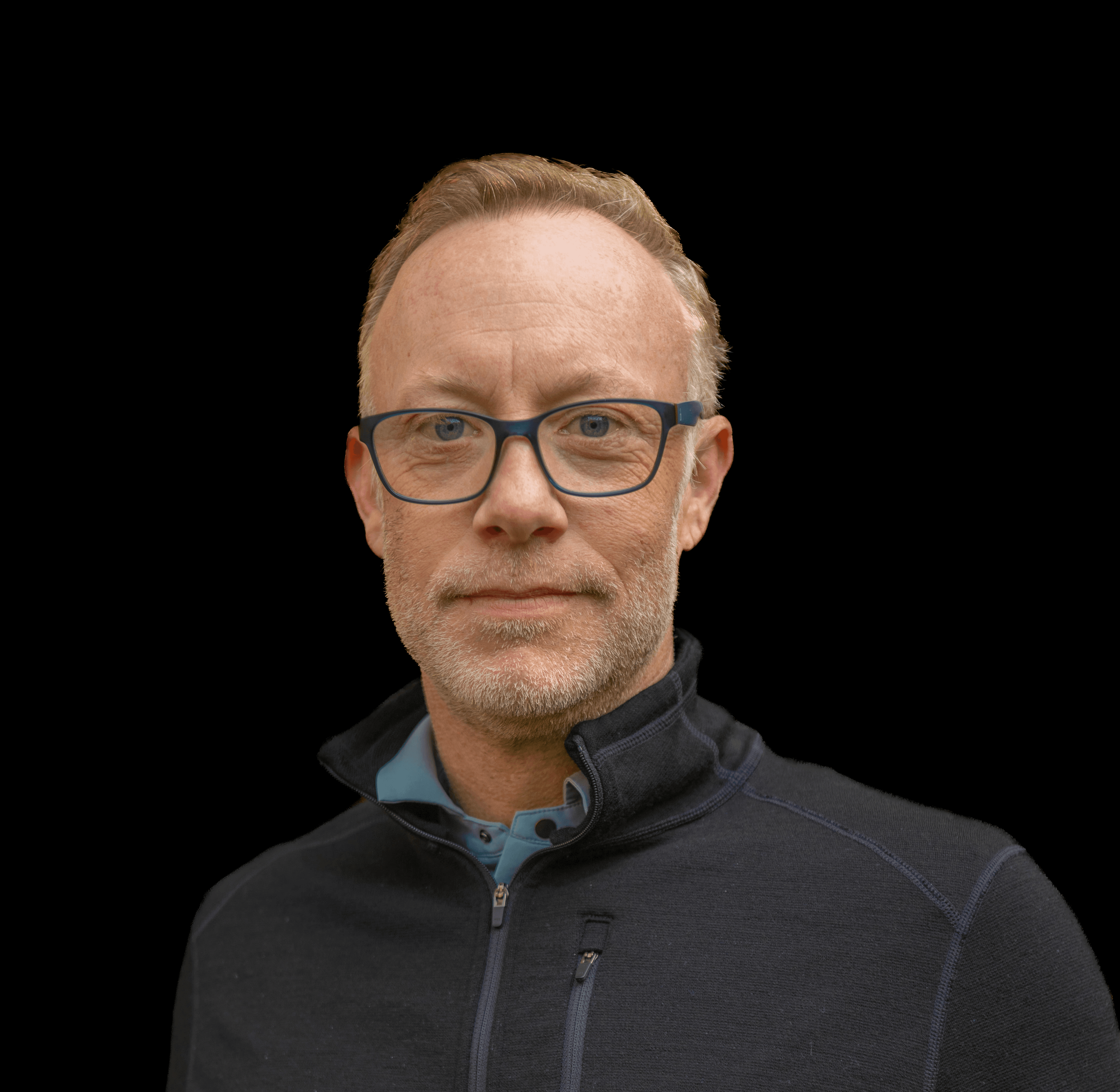 headshot of male in dark background