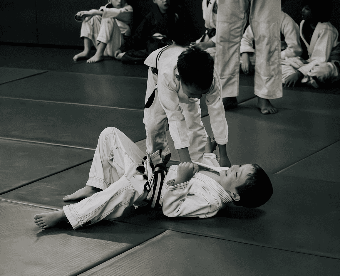 Two students drilling a ground technique during Jiu Jitsu training