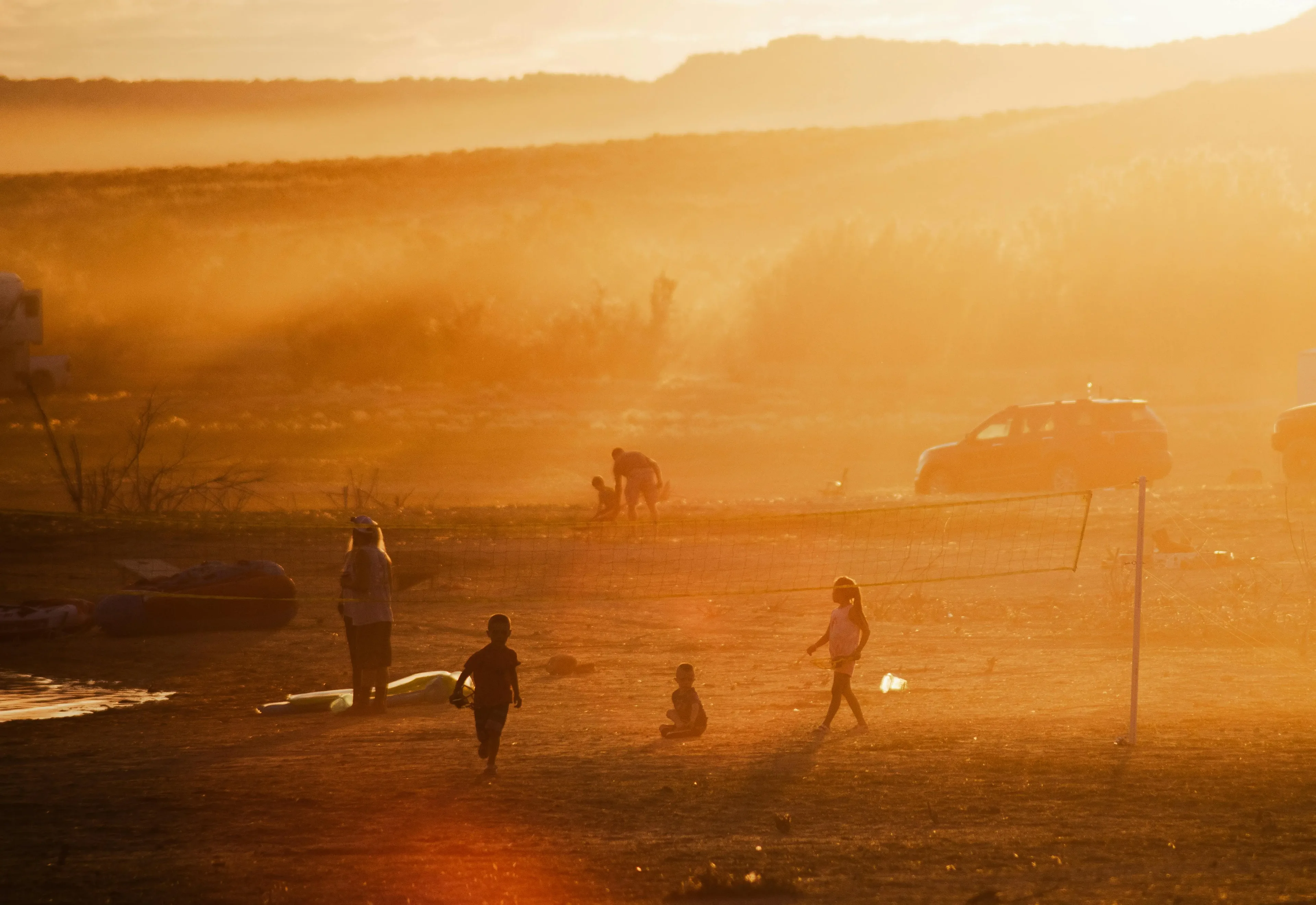 People on field in dusty sunshine