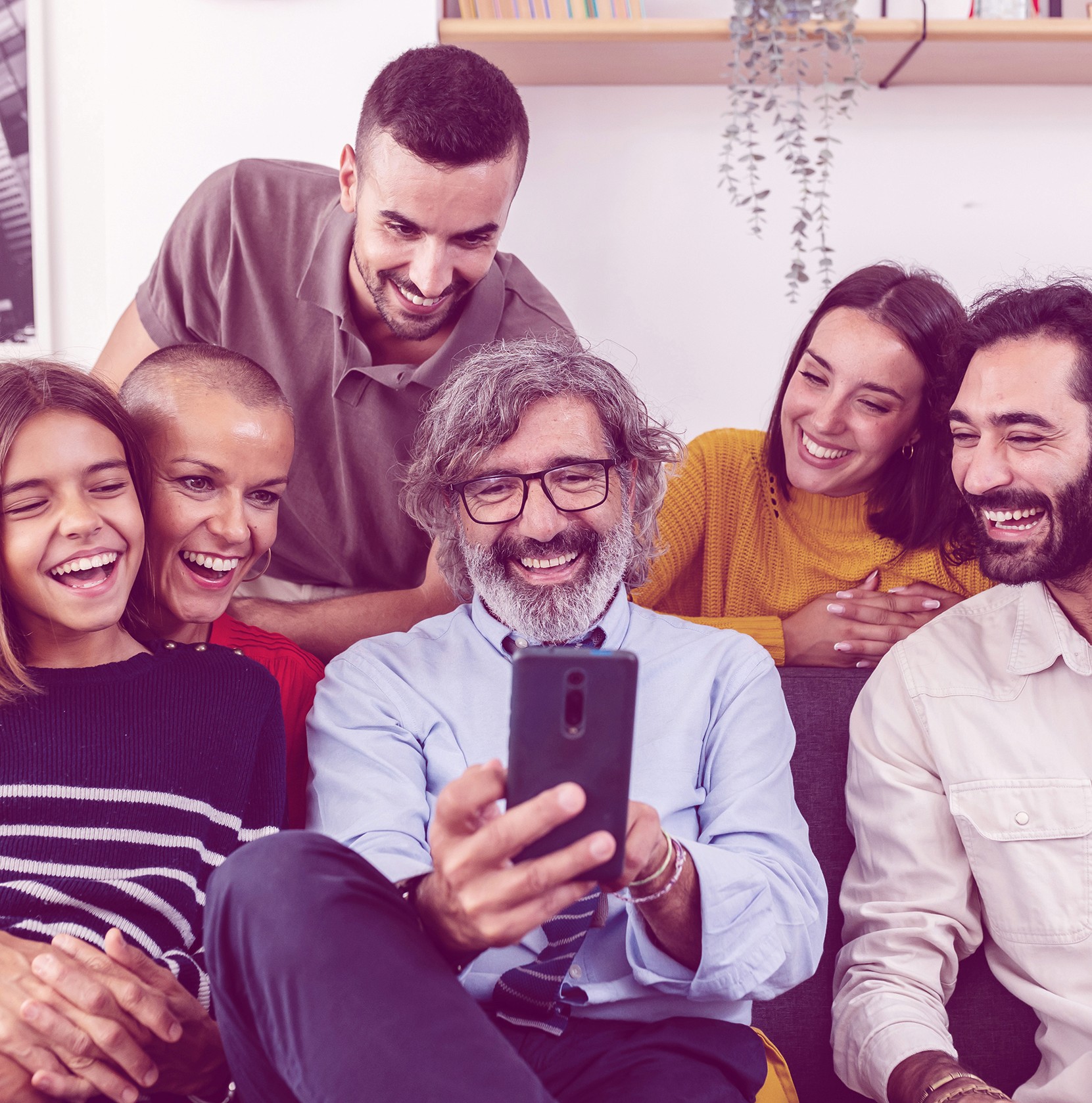 two people looking at a tablet and smiling