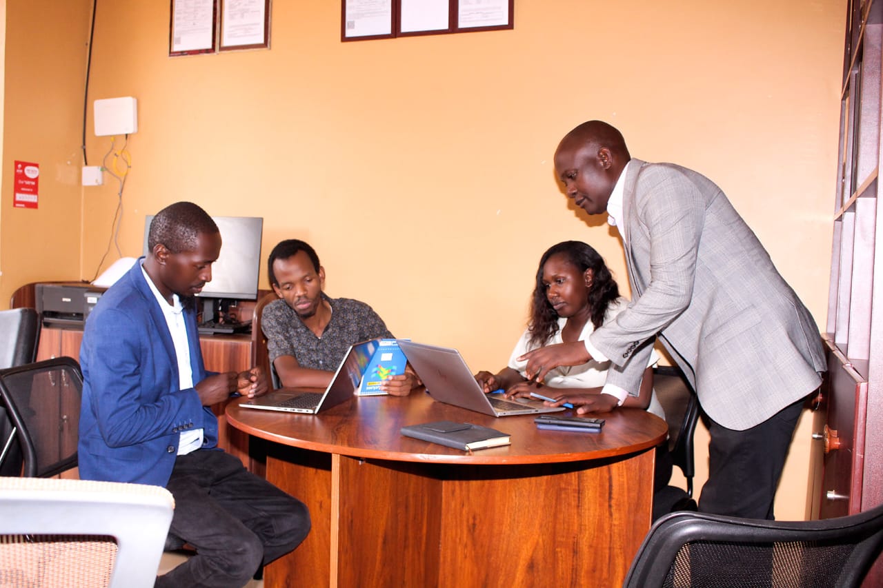 Moodplex Ventures Group Ltd staff reviewing business documents, Uganda office