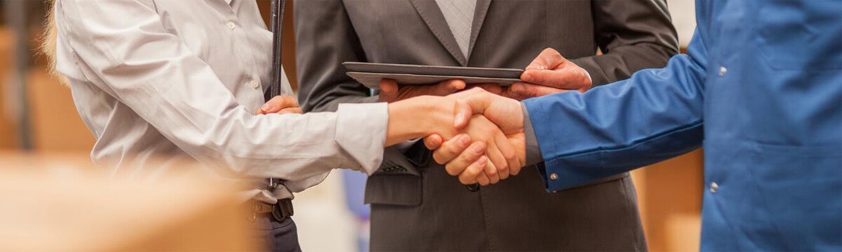 Two healthcare professionals shaking hands.