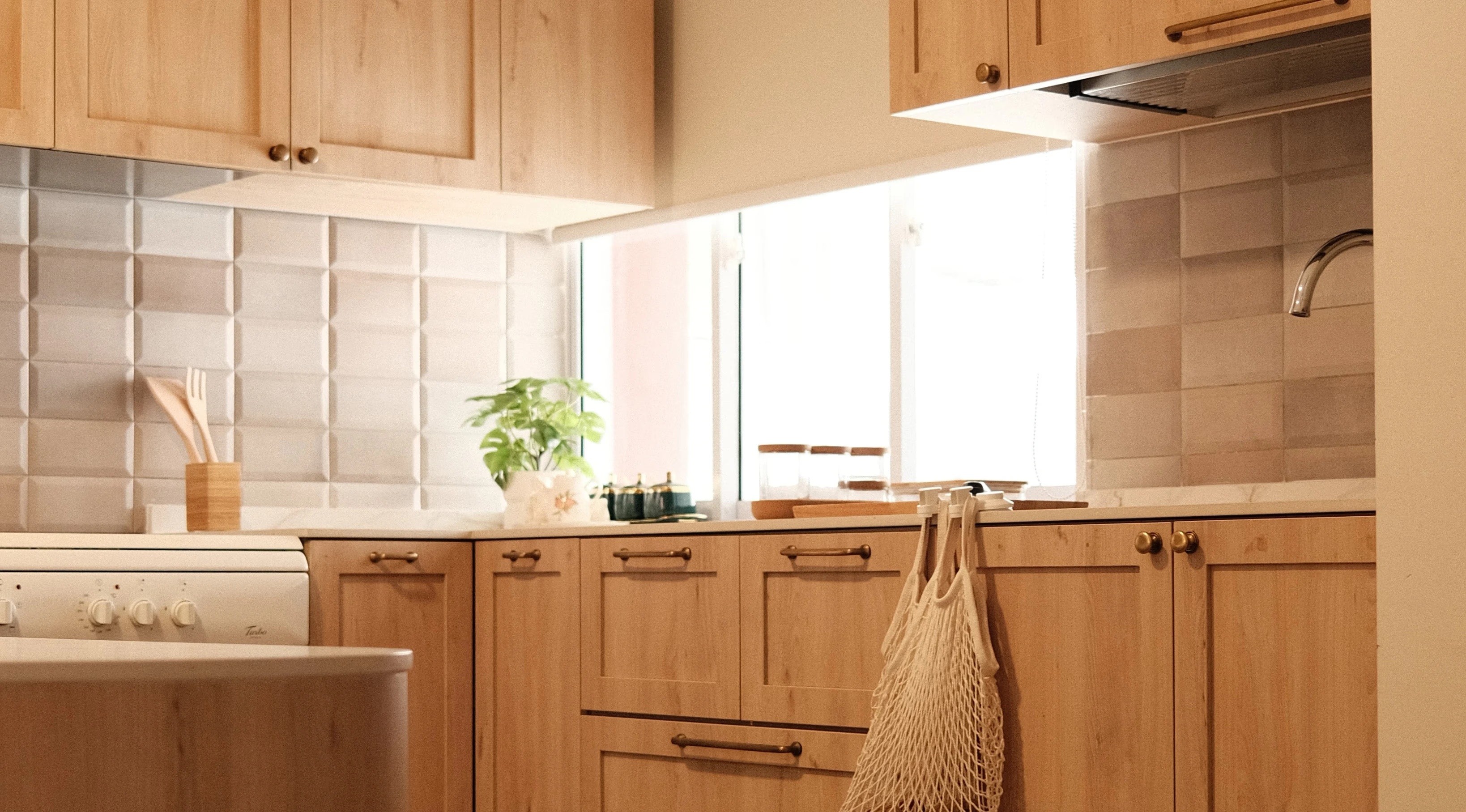 Modern kitchen renovation with light wood cabinets, farmhouse sink, and open shelving by Persqft Singapore