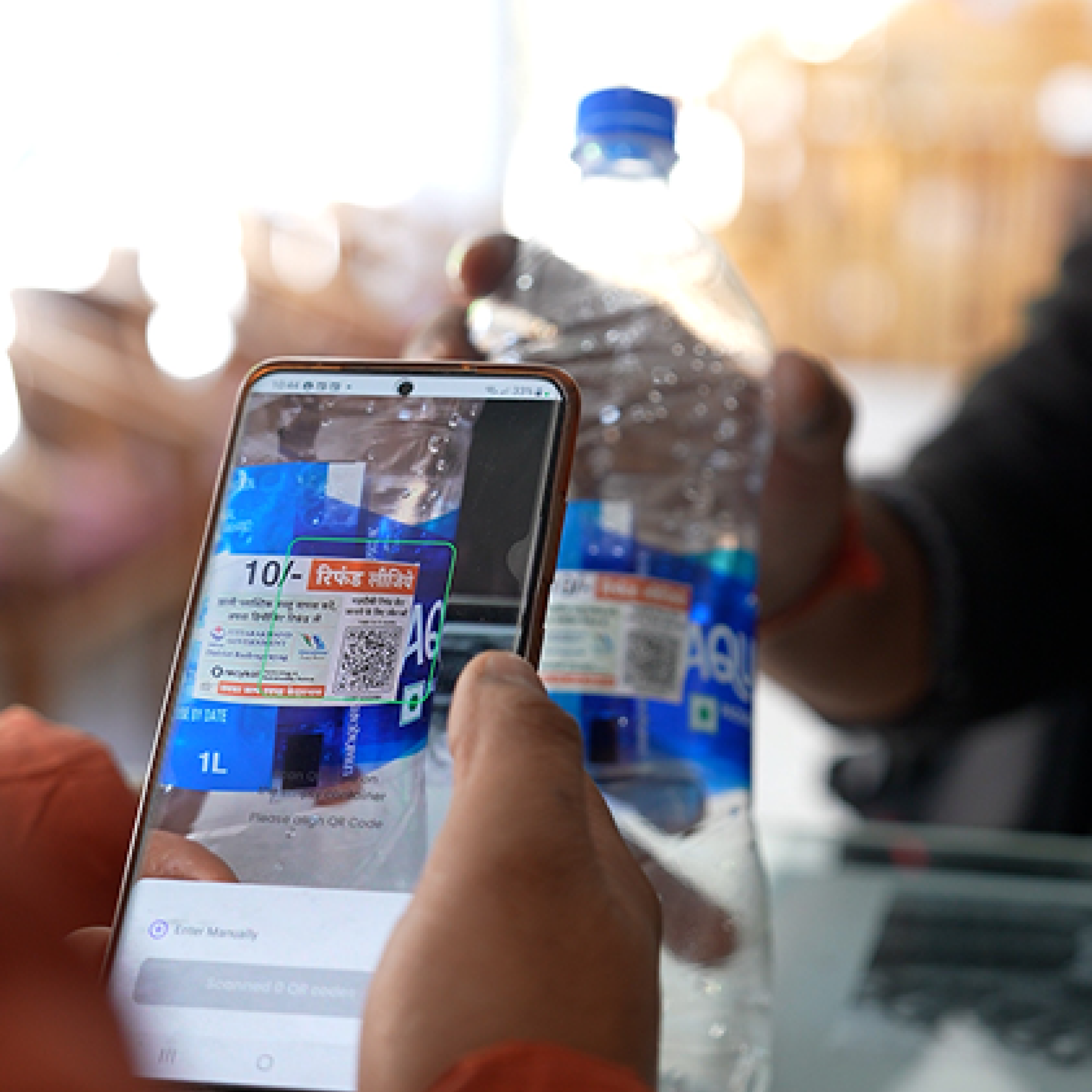 Woman in red outfit poses by a red telephone booth.