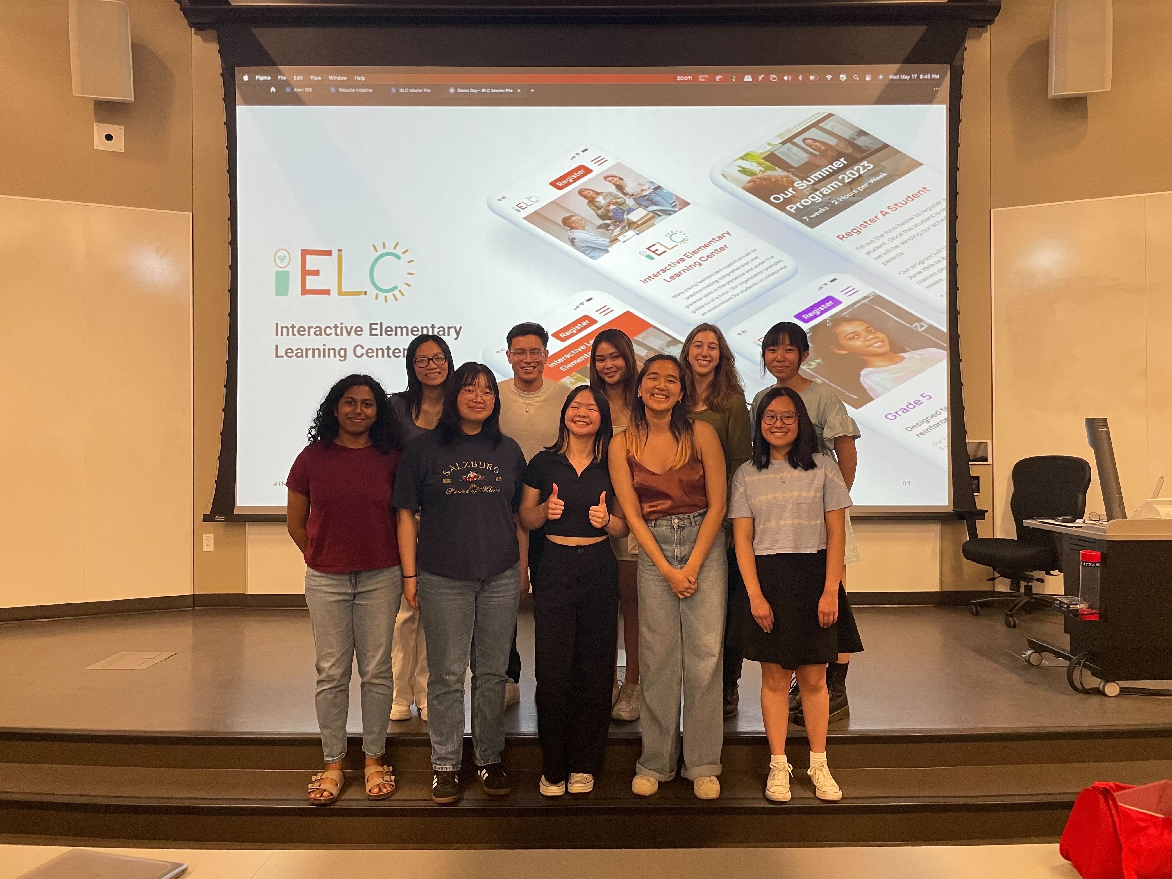 Group picture of 10 people in front of a projector