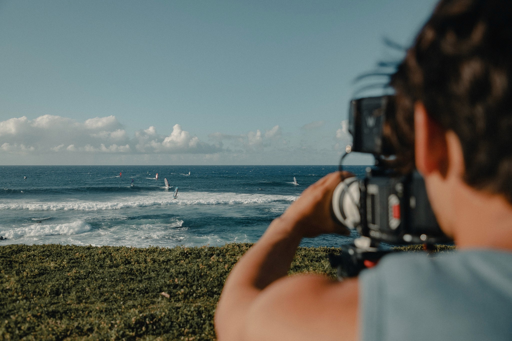 filming windsurfers from a cliff in maui