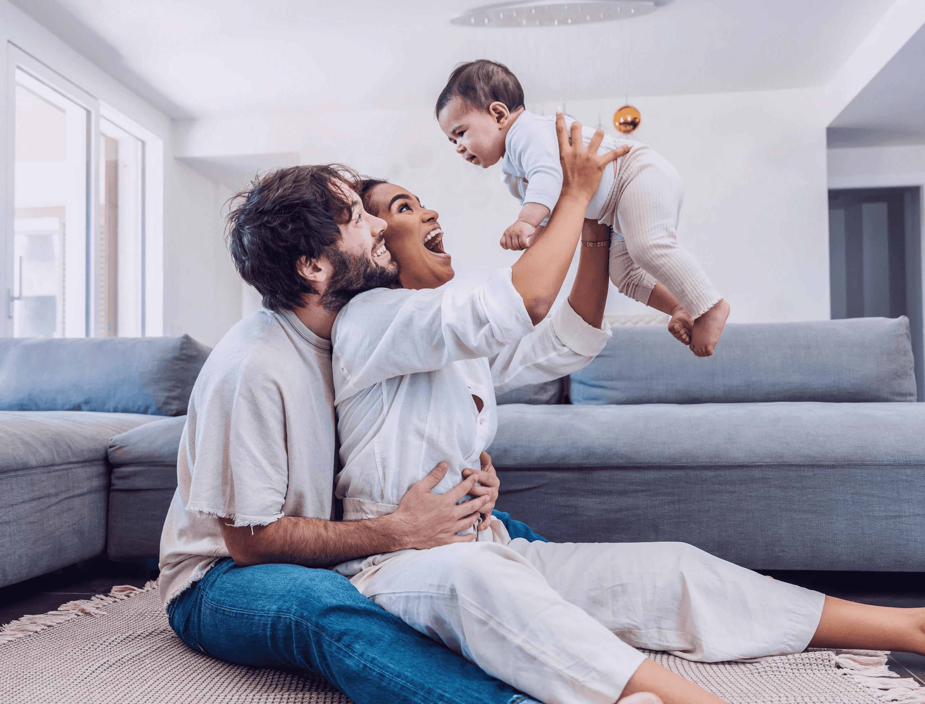 Parents holding up a baby