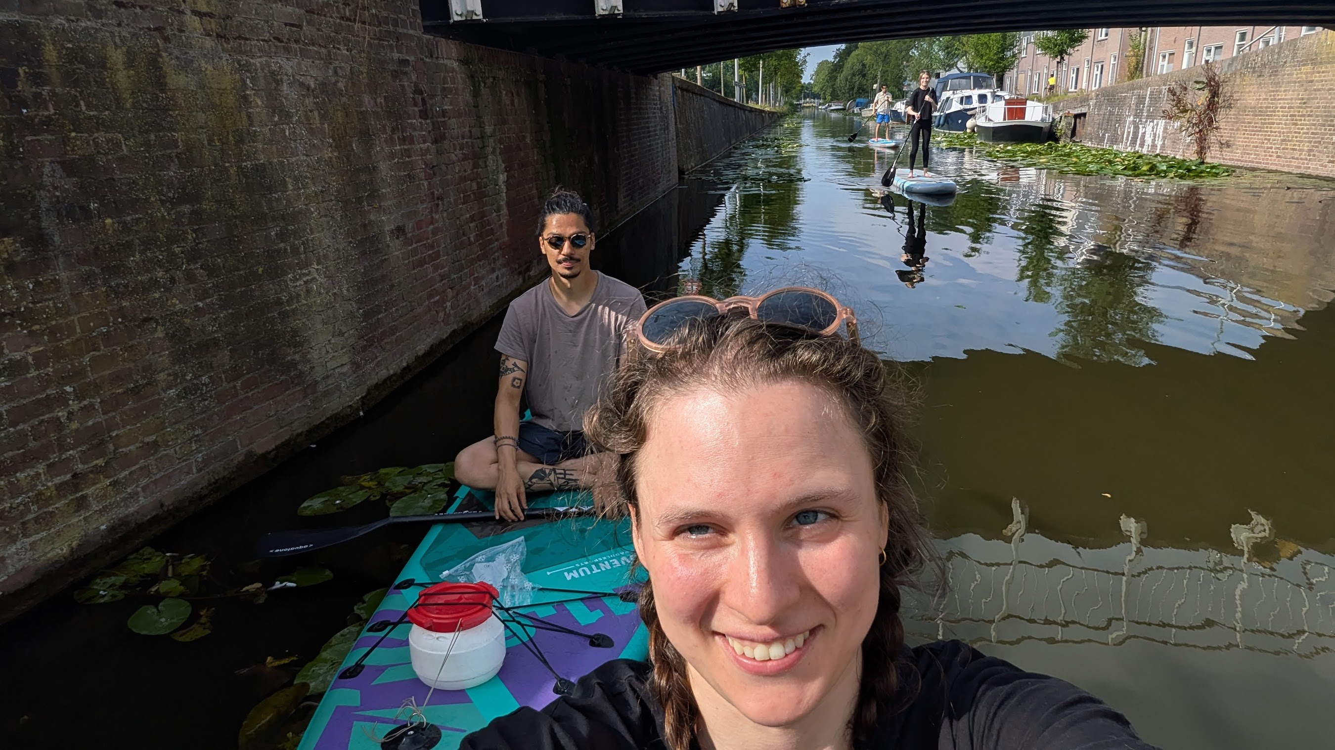 A beautifully set dining table with white tablecloth, cutlery, and fresh greenery in a cozy, well-lit space.