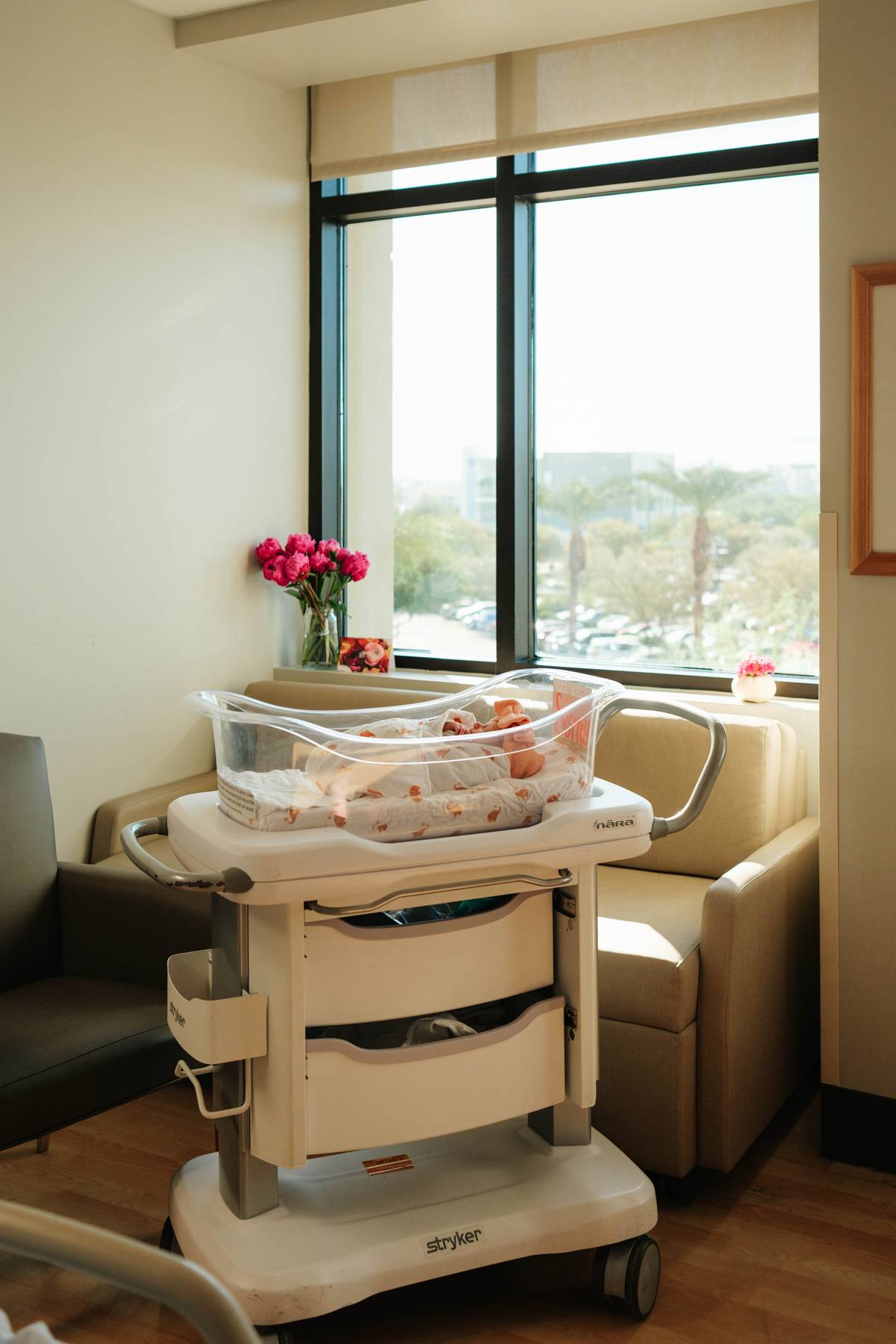 Candid photo of newborn feet in a soft, light-colored sleeper, a common element in newborn lifestyle photography.