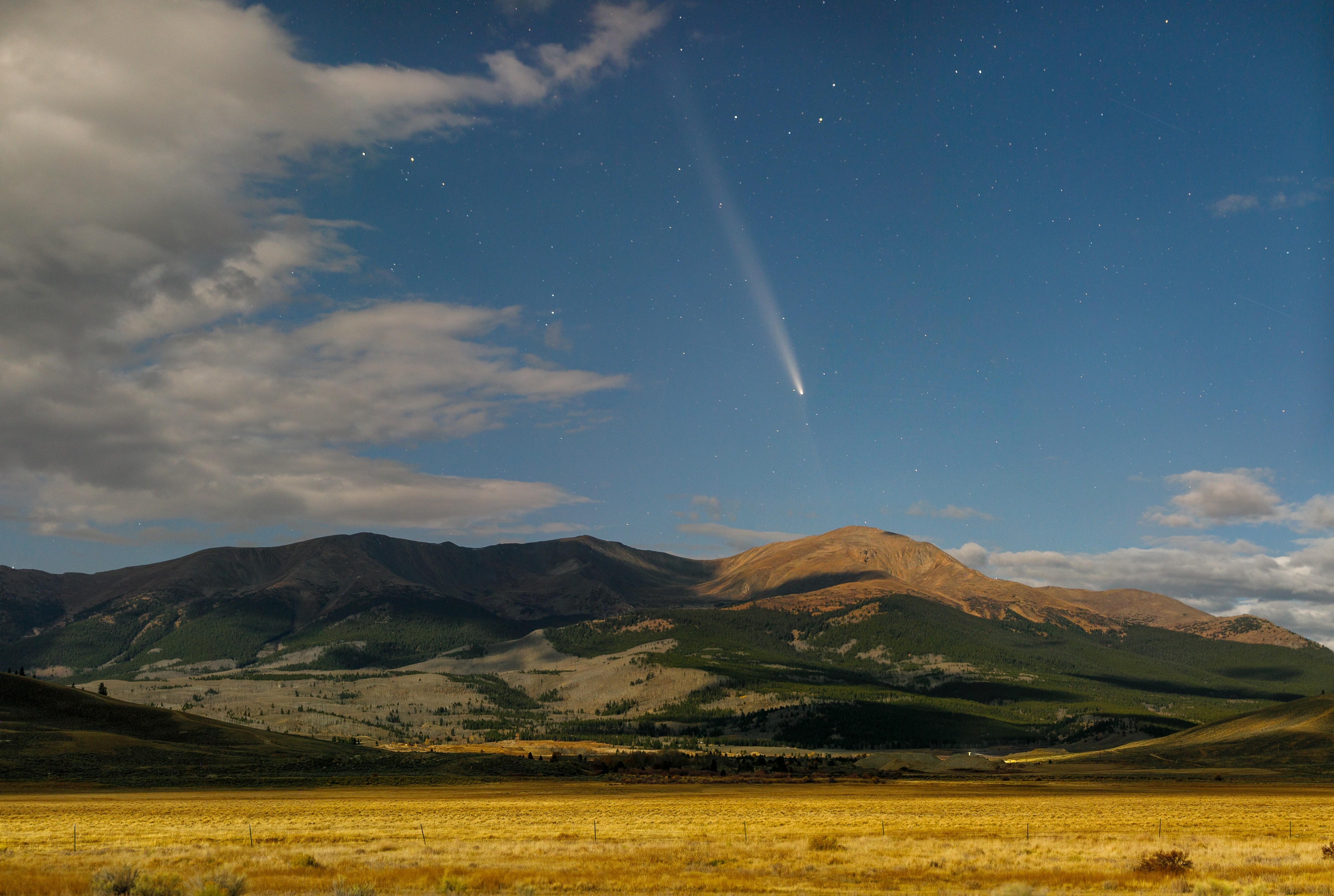 Panoramic landscape photograph of mountains, water, desert, or coast by Lucas Jensen