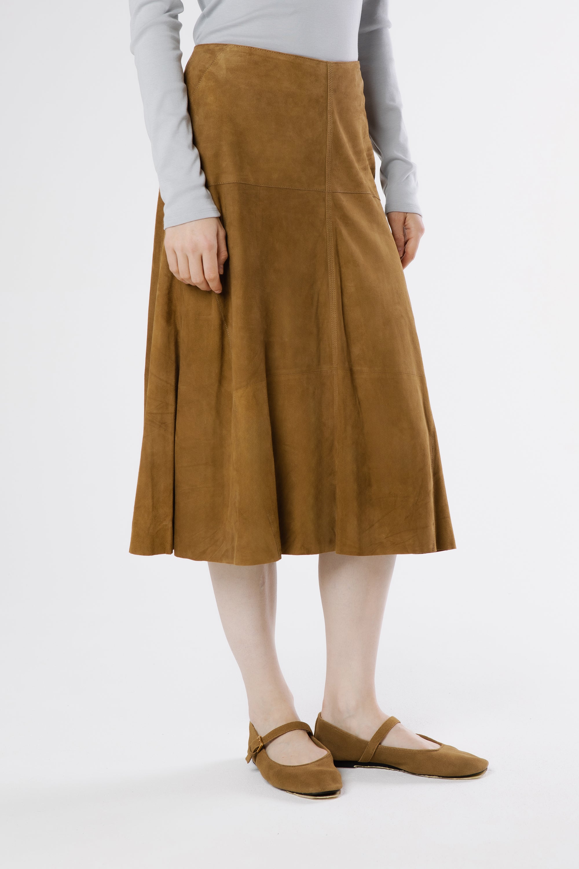 Side view of Milano suede midi skirt in oak highlighting gentle flare and natural movement