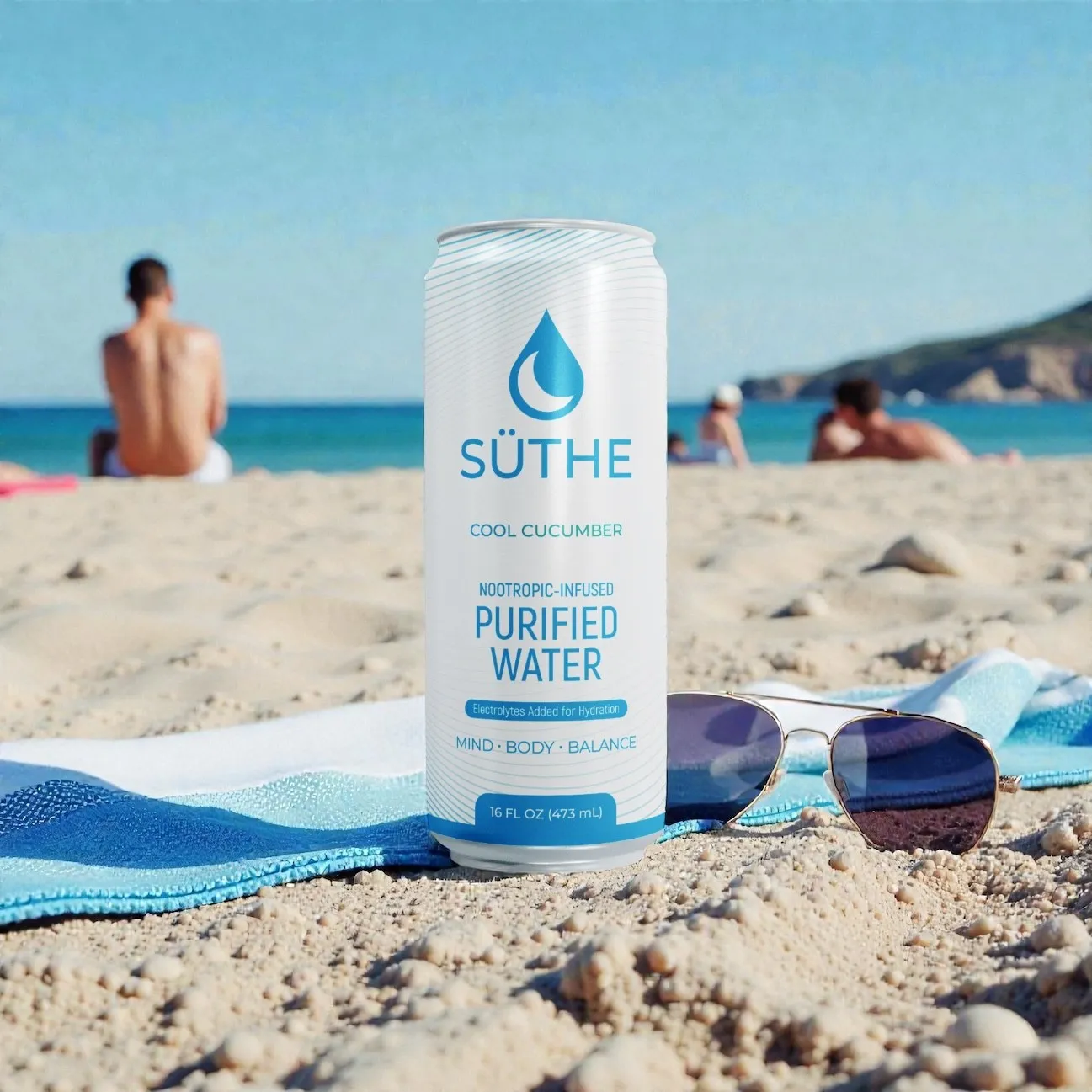 Süthe Cool Cucumber Nootropic Purified Water can on a sandy beach with sunglasses and towel.