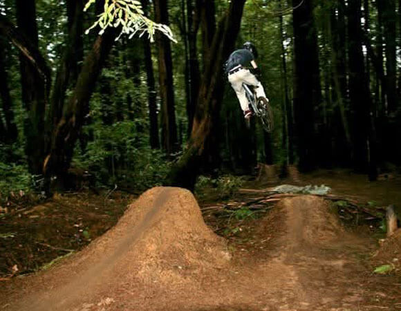 Donny jumping the gap on his mountain bike.