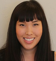 A photo of a smiling woman.