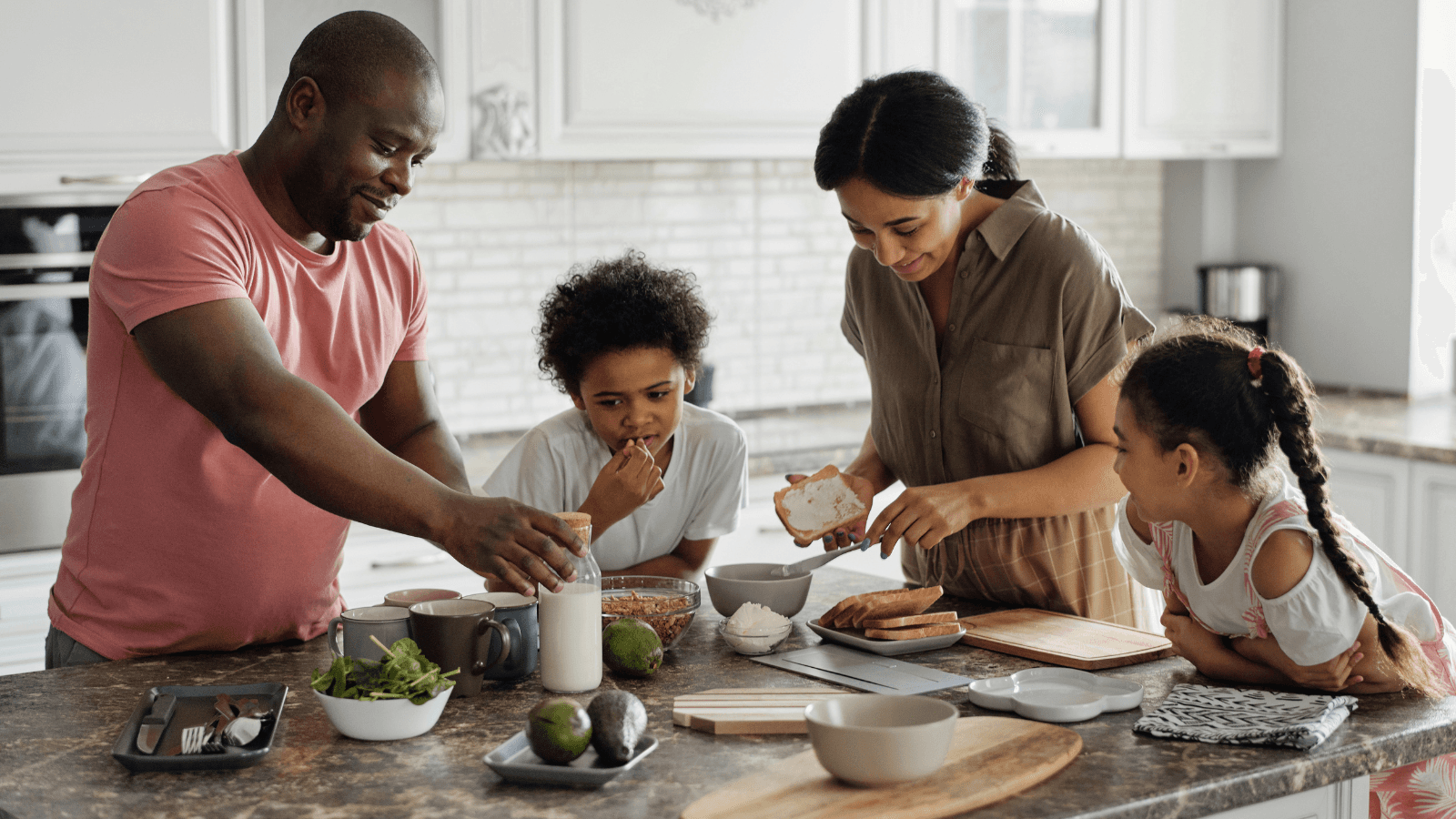 Family gathered around the table making breakfast