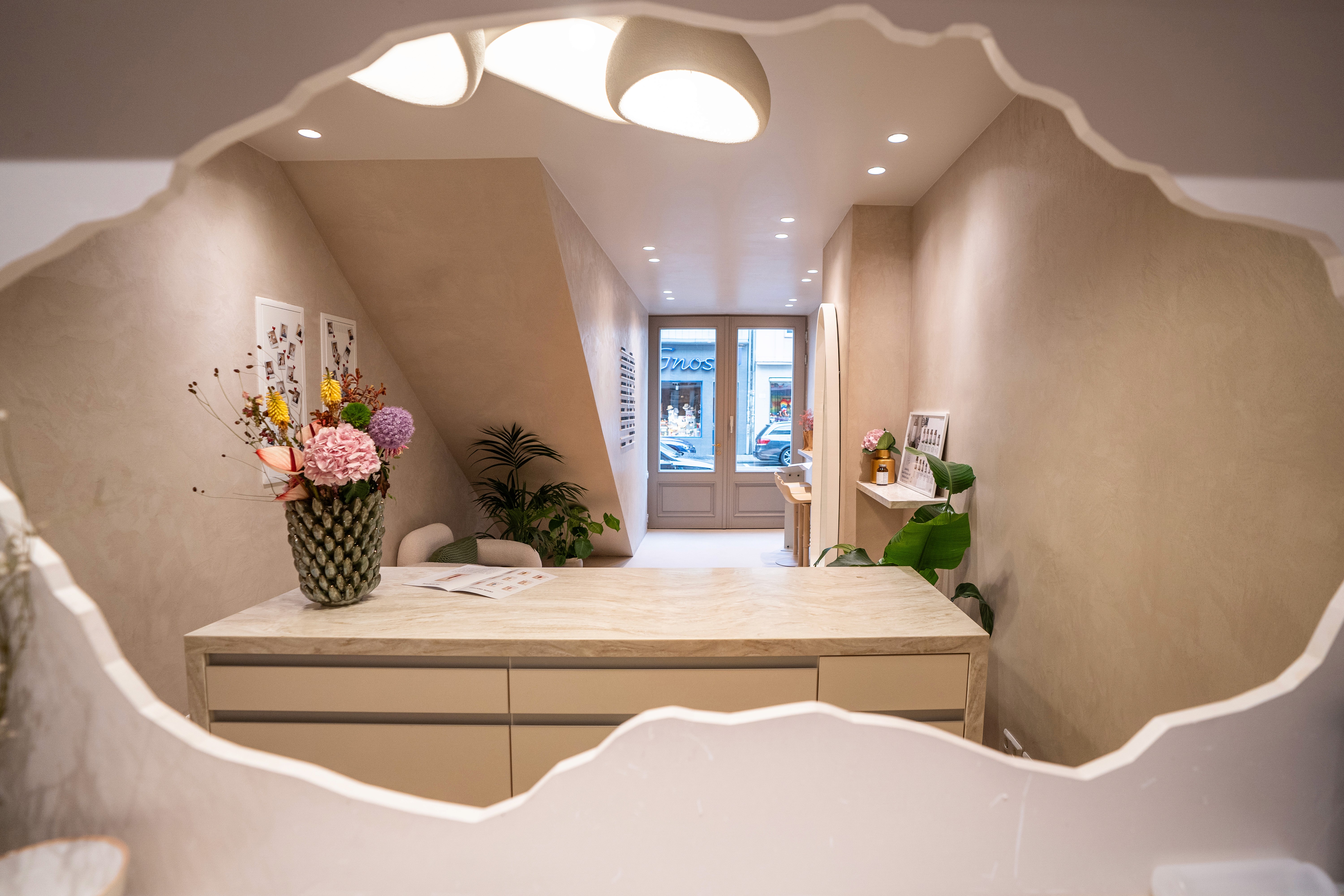 Smiling barista holding green cup at coffee machine