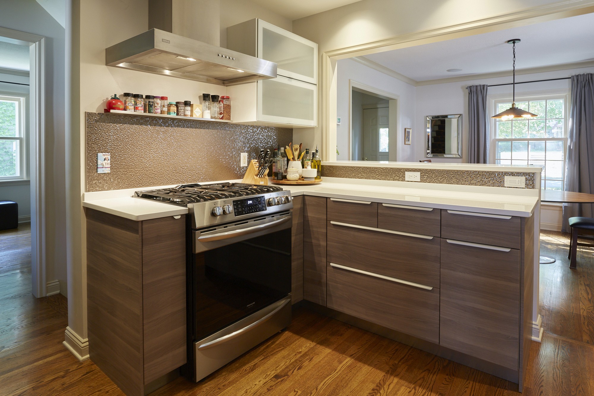 Gray cabinetry with metallic mosaic backsplash and stainless gas range, Diamond Lake kitchen