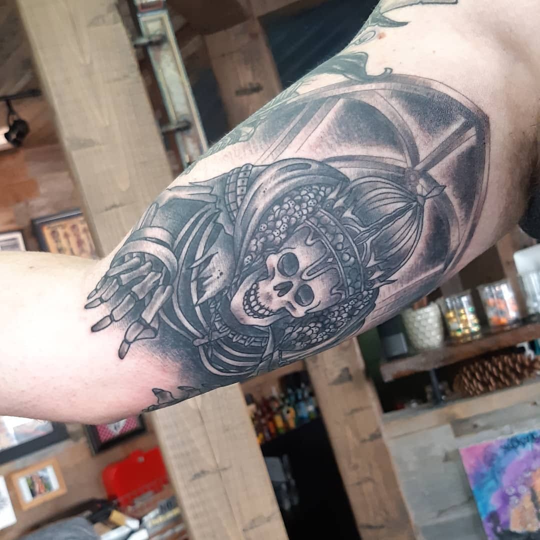 Black-and-grey portrait sleeve tattoo on a forearm