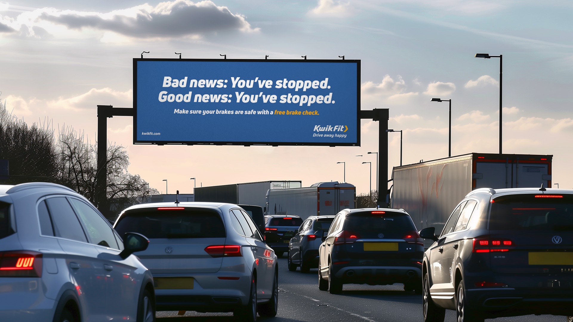 Billboard above a traffic jam that reads 'Bad news you've stopped, good news: you've stopped'