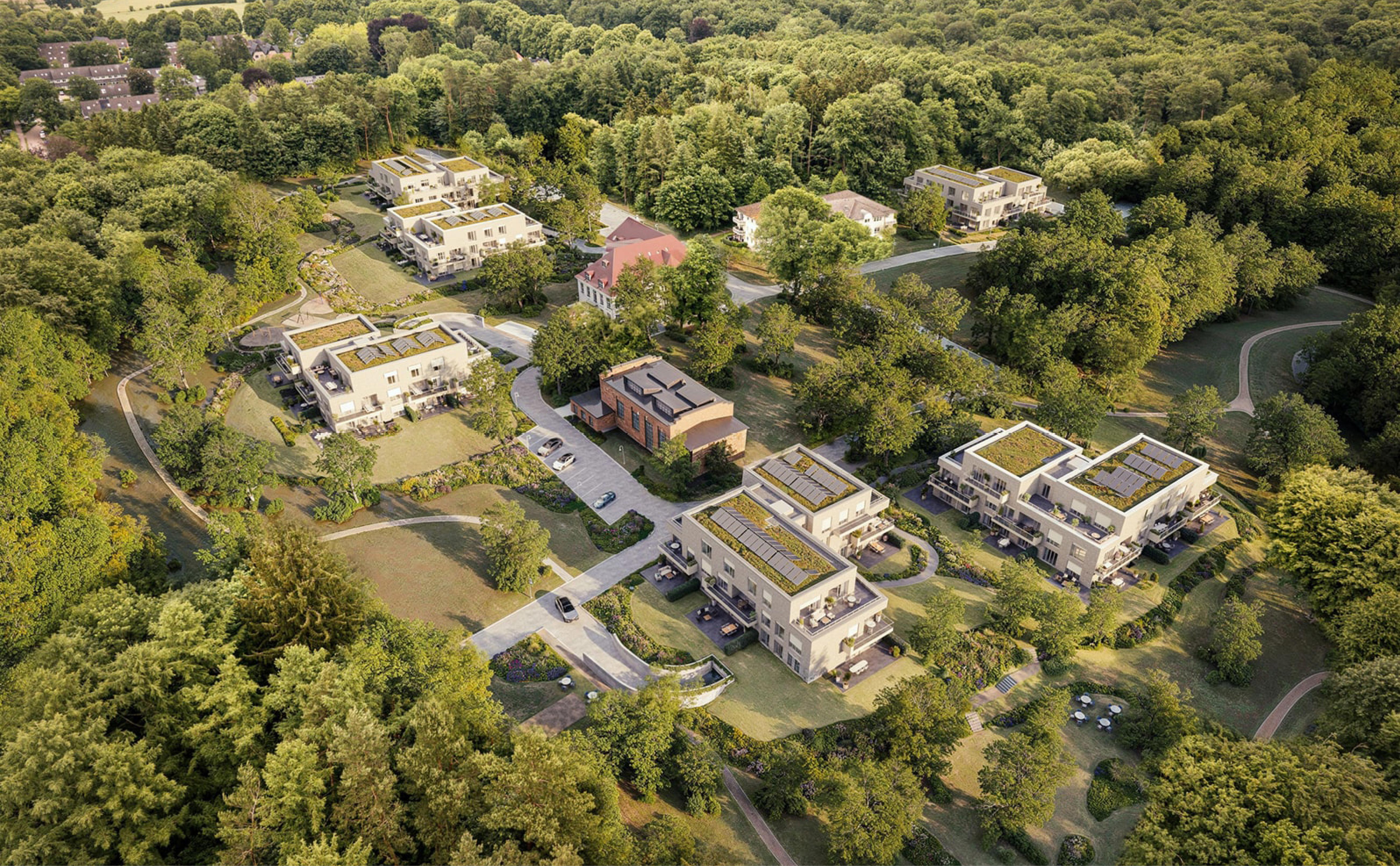 Architektur-Visualisierung des Immobilienprojekts Gut Leeven aus der Vogelperspektive, eingebettet in eine weitläufige Wald- und Parklandschaft.