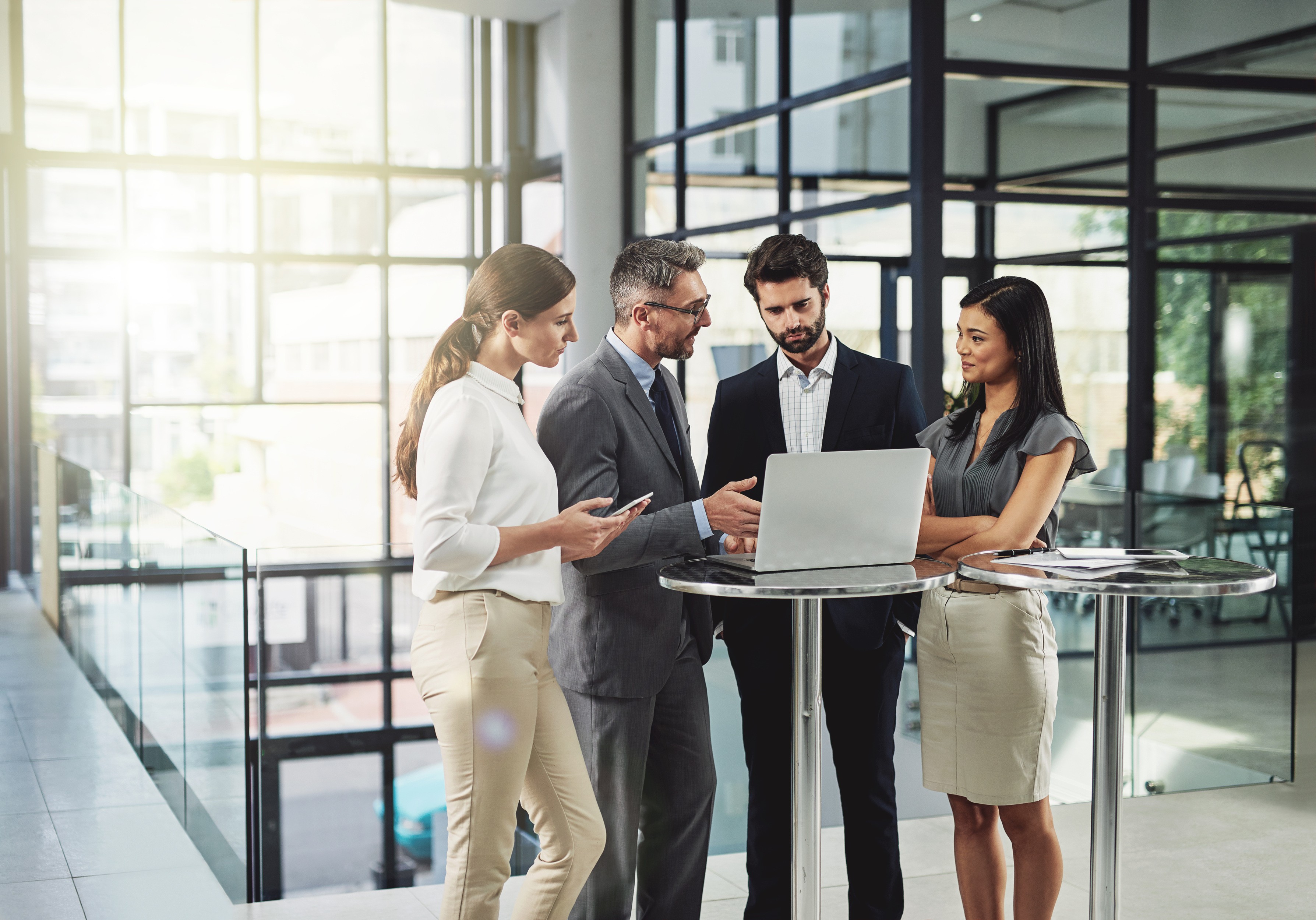 four men looking to the paper on table