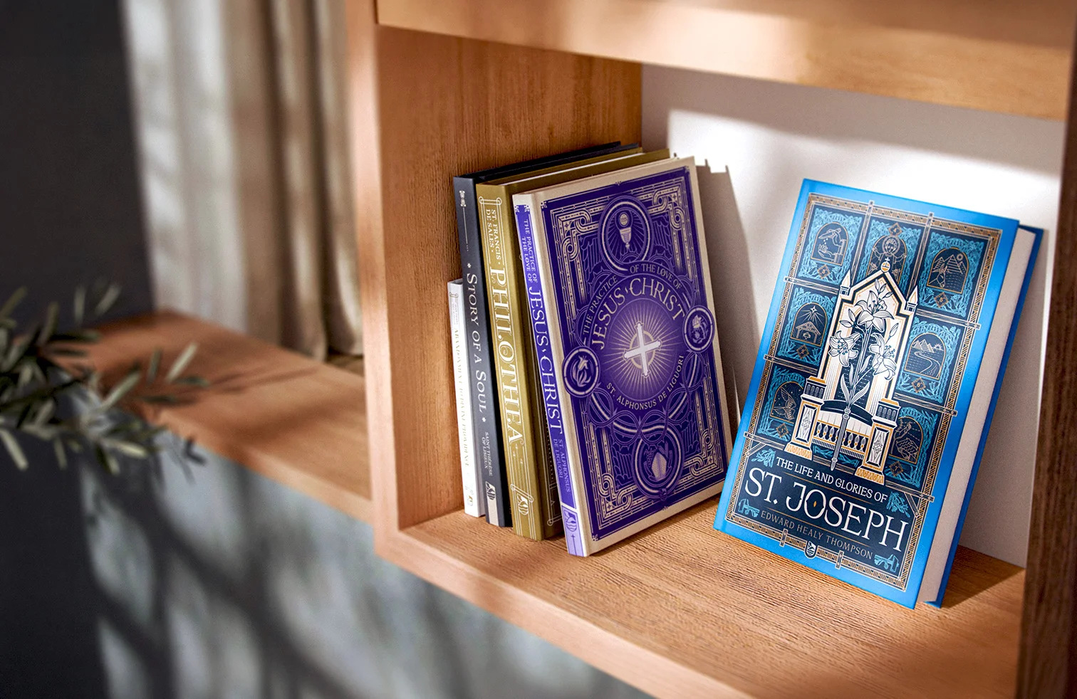 Titled books rest on a wooden shelf. The spines of several books, including "Story of a Soul" and "Philothea," are visible on the left.