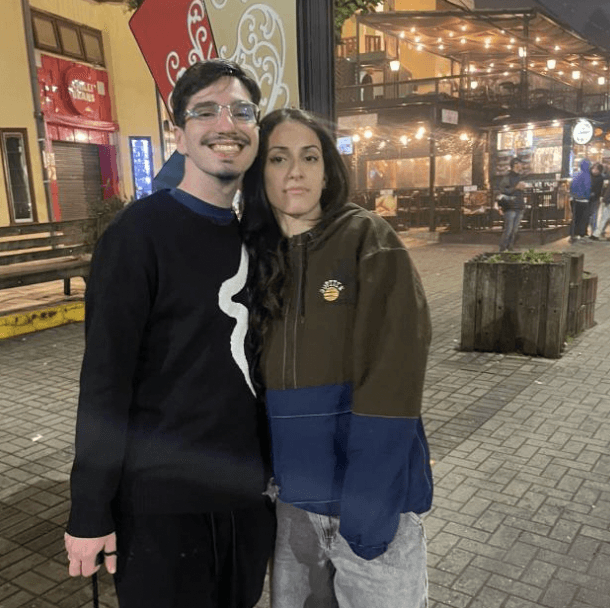 a man wearing glasses and a black shirt