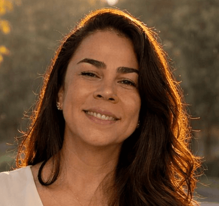 Sara is a client smiling to the camera happily