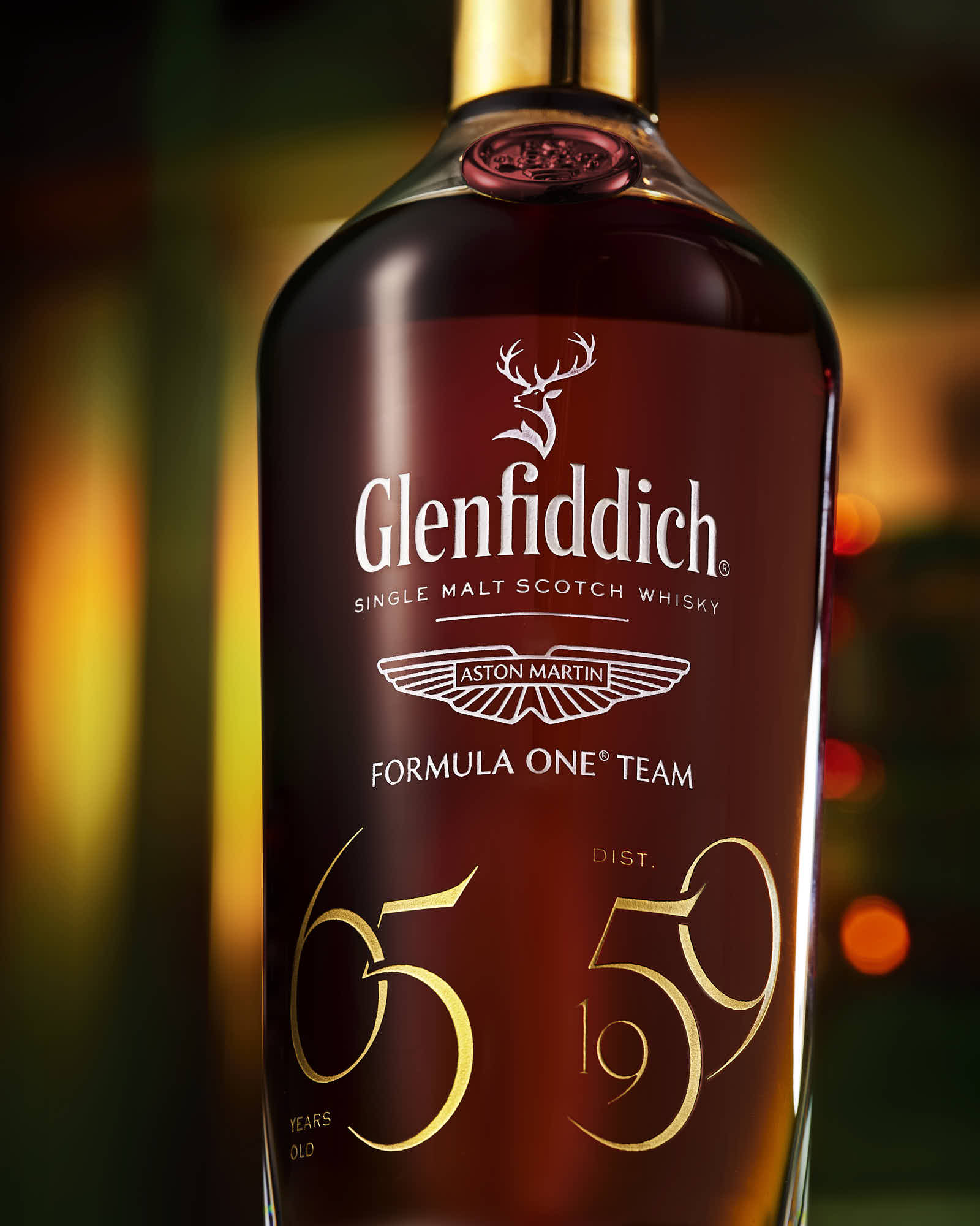 A bottle of whiskey, prominently displaying its label with a design and the number "65." Softly lit background.