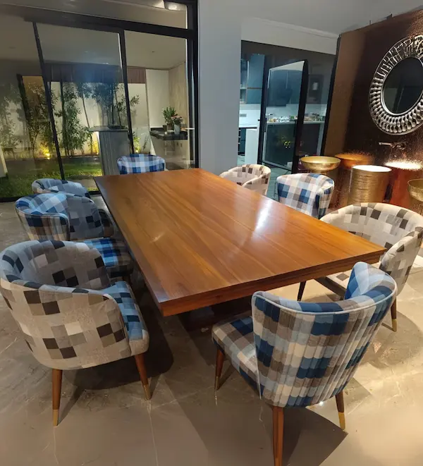 Luxury contemporary wooden dining table paired with patterned upholstered chairs