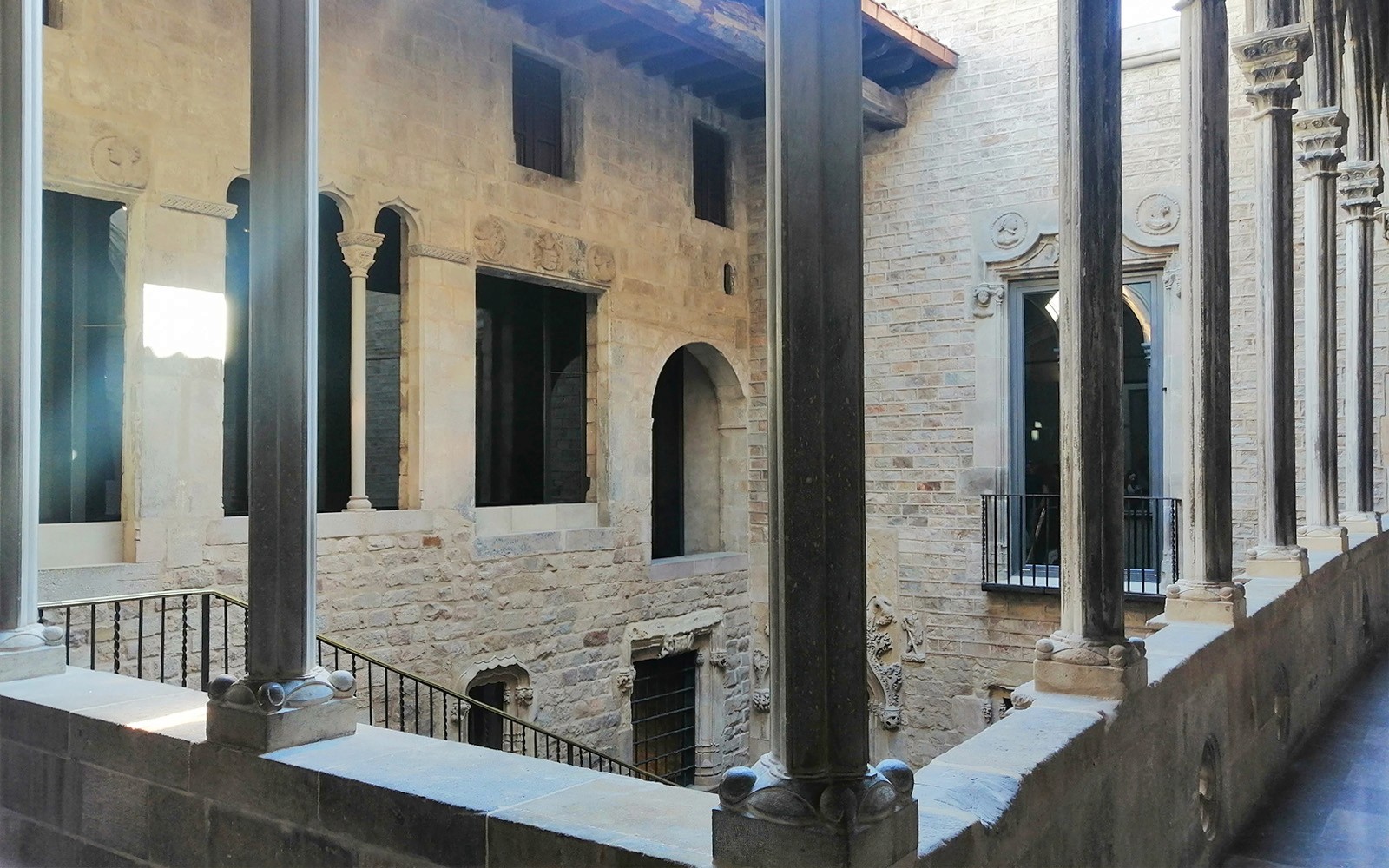 Stone courtyard with arches and columns at Picasso Museum, Barcelona.