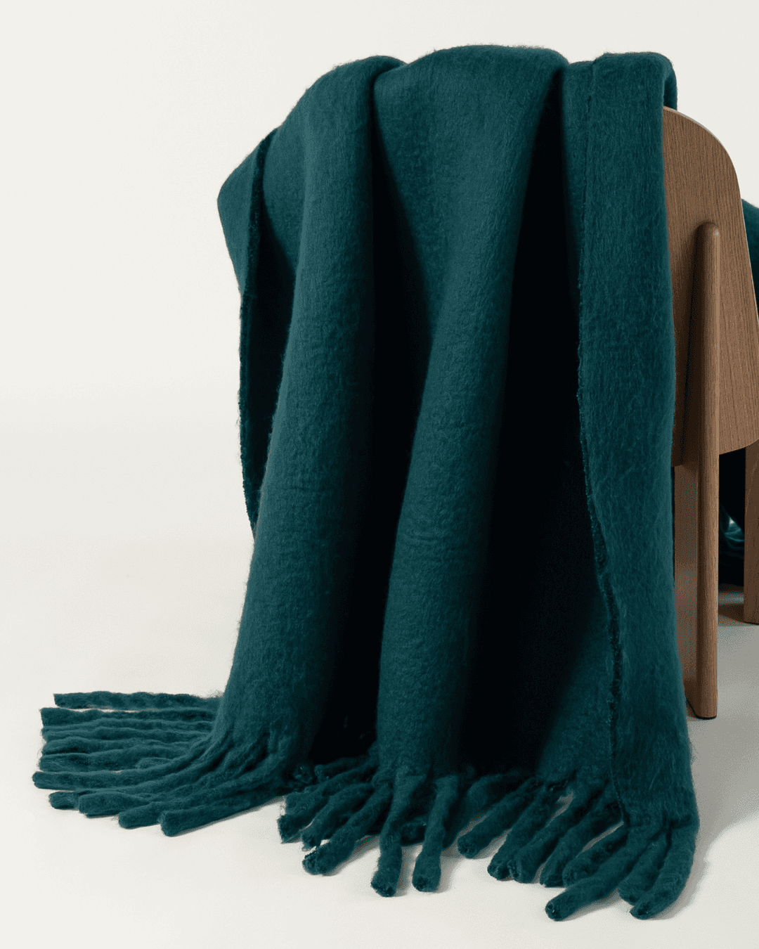 Faux mohair blanket in alpine draped on wooden chair