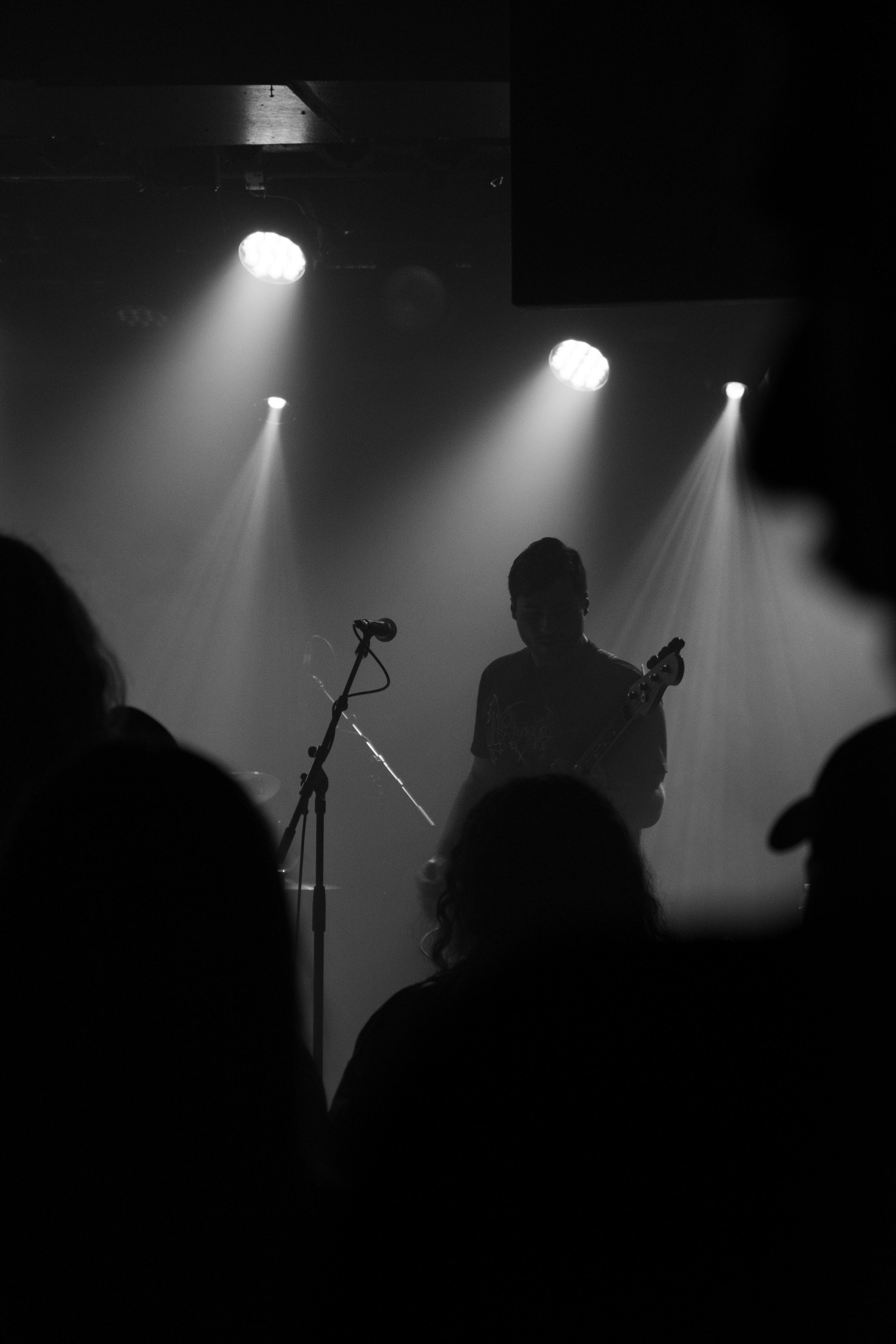 Guitarist performing on stage in silhouette