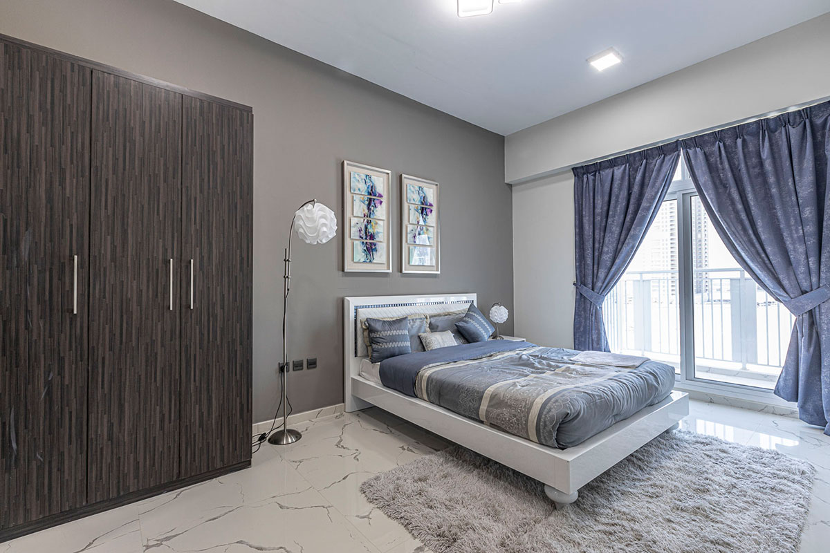 Elegant bedroom interior in a Geepas Tower apartment, listed by professional real estate services.