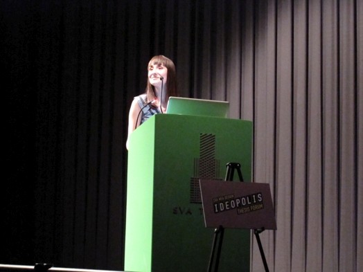 a student giving a speech from the green stand in the amphitheater