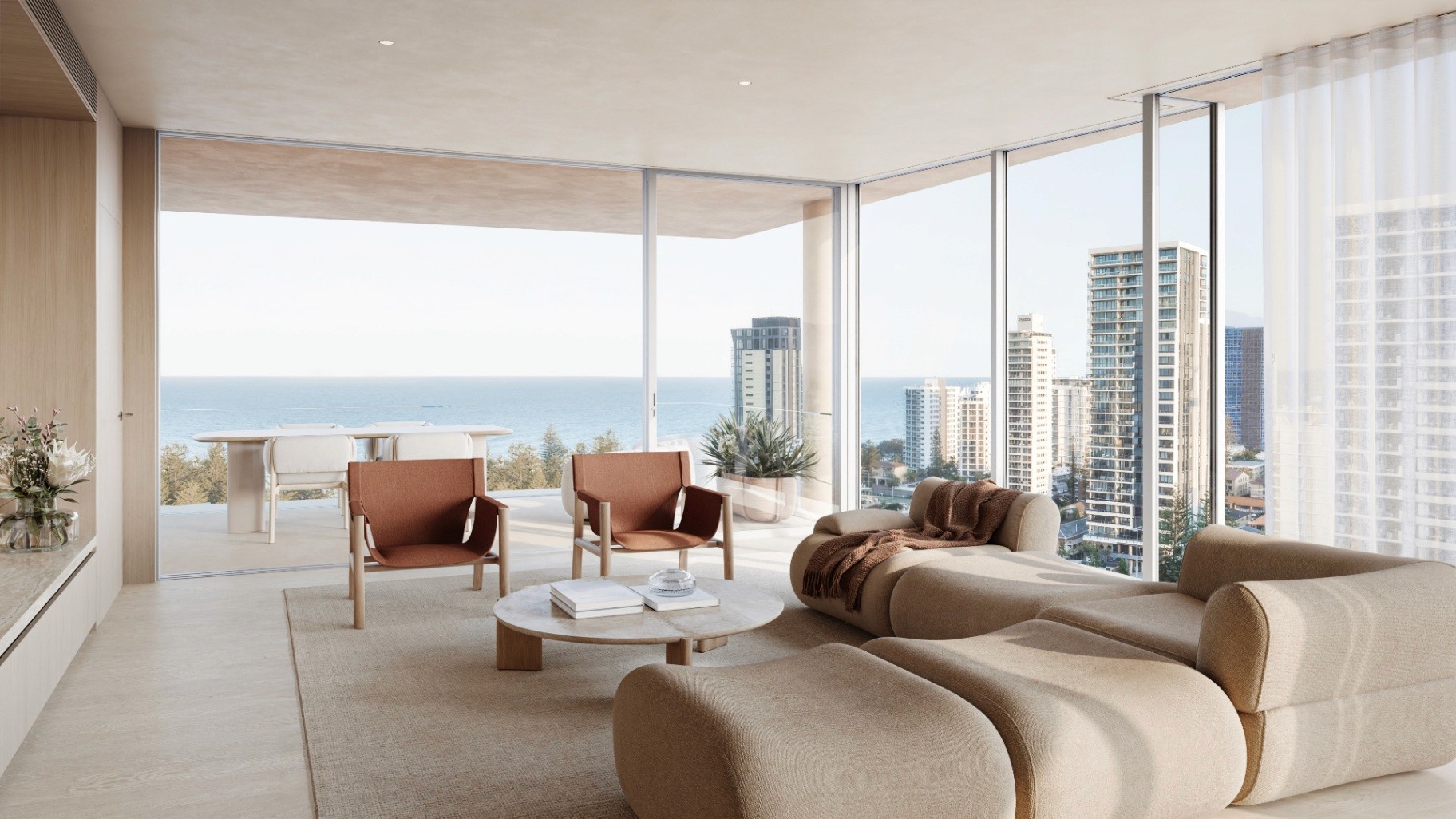 Light-filled living room at Camilla Broadbeach with floor-to-ceiling glass and sweeping ocean and skyline views.
