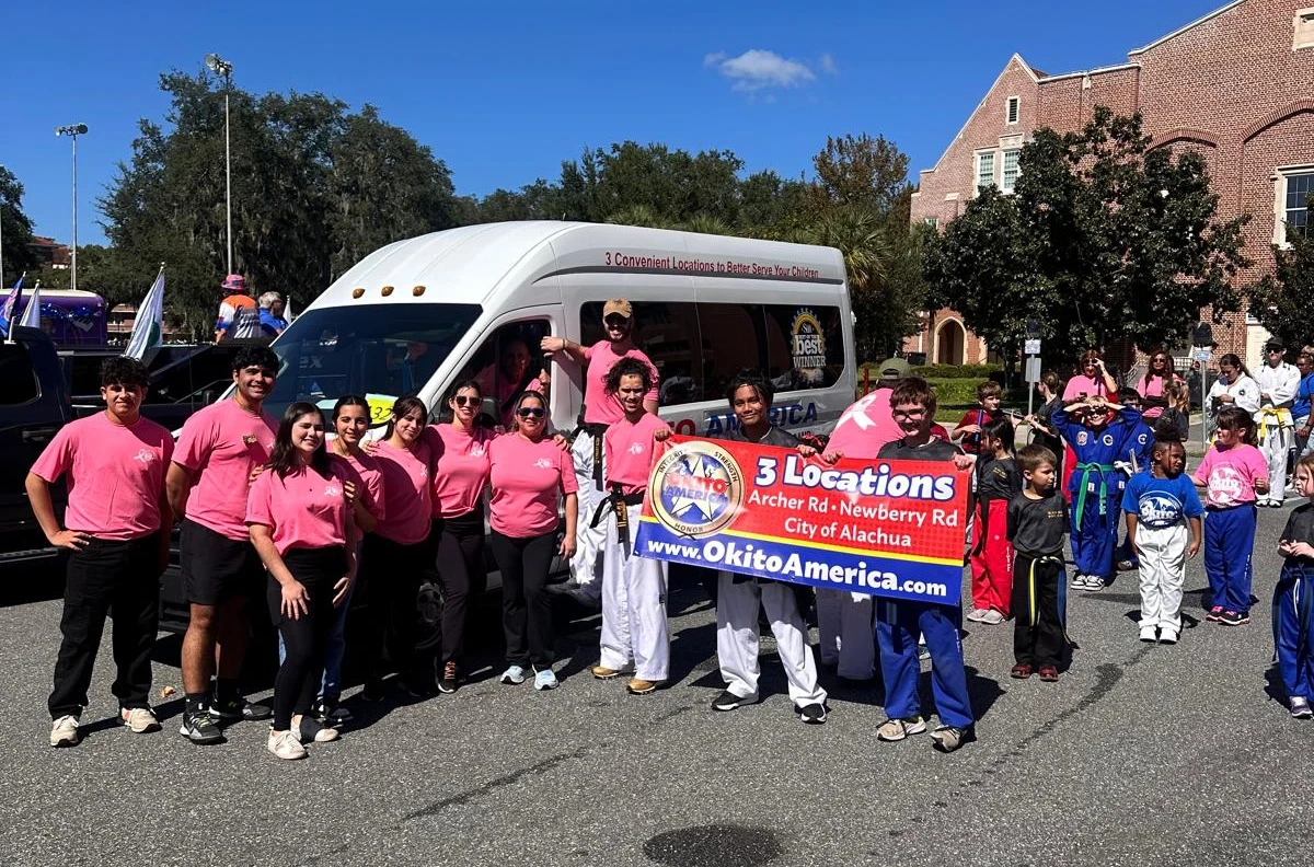 Okito team and students getting for to walk in a parade.