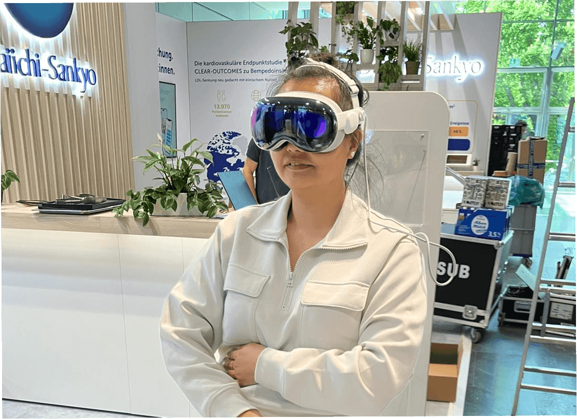 Four diverse professionals collaboratively working on a laptop, with one person pointing at the screen while others observe.